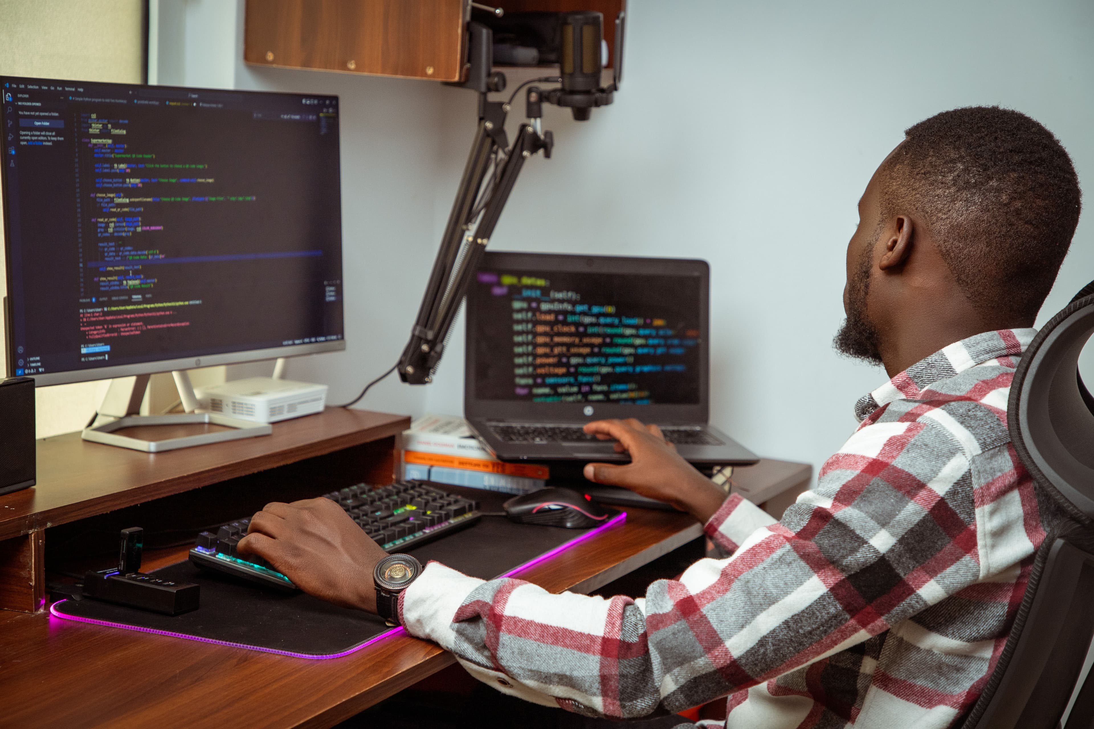 Software developer working at a multi-screen workstation in Nairobi